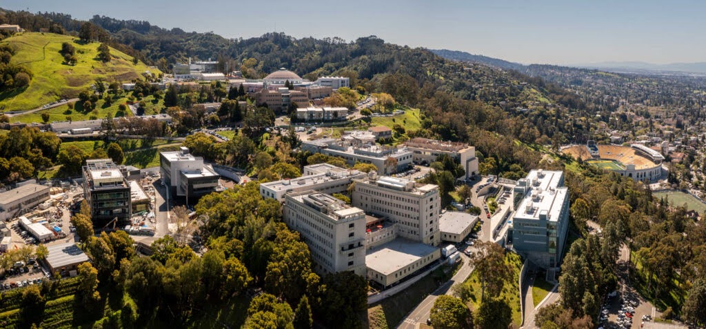 Lawrence Berkeley National Laboratory (Berkeley Lab) as seen from an aerial drone camera viewed looking towards the Berkeley Hills with (left to right) the BioEPIC construction in progress, the Integrative Genomics Building (IGB, Building 91), the Building 50 complex (foreground), the Advanced Light Source  (ALS, Building 6), Building 59 (Wang Hall, NERSC) and other buildings on the West side of the lab campus, 04/14/2023.